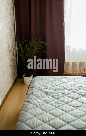 tucked bed in a room with sunlight Stock Photo - Alamy