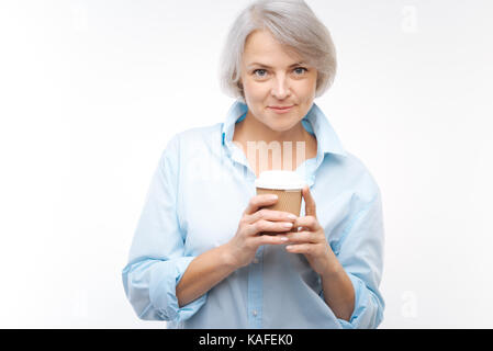 Charming grey-haired woman posing with coffee cup Stock Photo