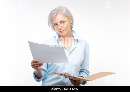 Beautiful woman looking through financial report Stock Photo