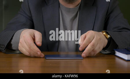 Teacher sits at the table with the record book Stock Photo