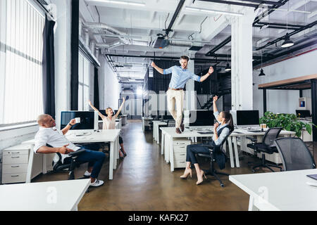 businessman dancing on table Stock Photo