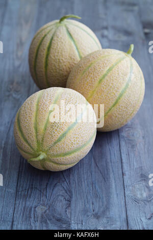 Fresh cantaloupe melons on wooden table. Stock Photo