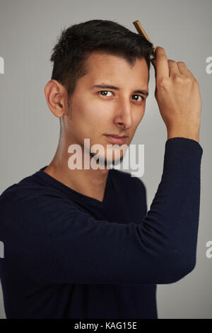 young-modern-arab-man-grooming-his-hair-