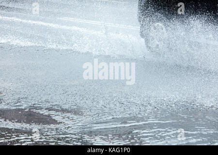 splashes of rain water from car wheels in motion closeup Stock Photo