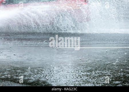 water splashes from car wheels in motion closeup Stock Photo