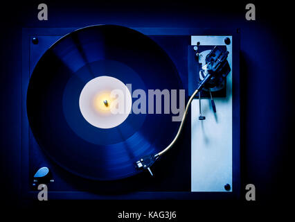 Vinyl long playing record, LP, on an old fashioned, retro,  record player turntable with tonearm Stock Photo
