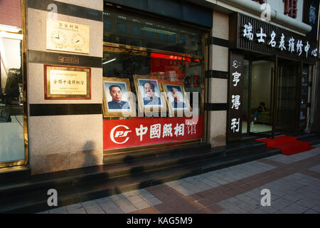 BEIJING, CHINA - SEP 17, 2017 : The photographs of Mao Zedong, Zhou Enlai and Liu Shaoqi at Wangfujing shopping street Stock Photo