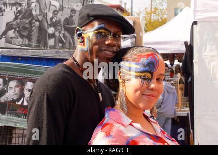 October 14, 2012 - Philadelphia, PA, USA:  A young African-American couple pose after having their faces painted at an outdoor festival. Stock Photo