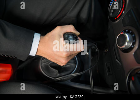 Close-up Of A Hand On Manual Gear Shift Knob While Driving Stock Photo