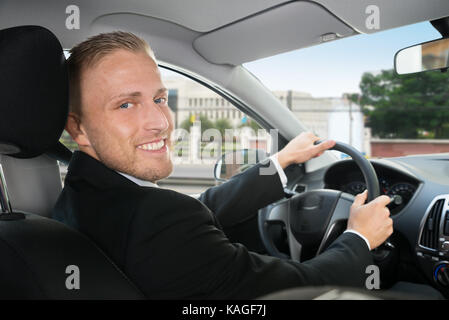 Portrait Of A Happy Businessman In His Car Stock Photo