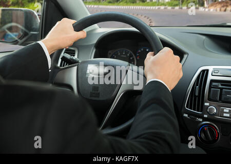 Close-up Of A Driver's Hand On Steering Wheel While Driving Car Stock Photo
