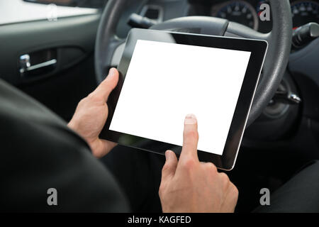 Close-up Of A Businessman Sitting In Car Holding Digital Tablet With Blank Screen Stock Photo