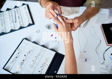 Woman Trying On Ring Sizes Stock Photo