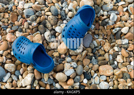 Child's beach shoes lost on beach Stock Photo
