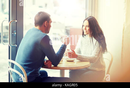 happy couple drinking tea and coffee at cafe Stock Photo