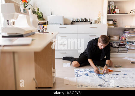 fashion designer making dress at sewing studio Stock Photo