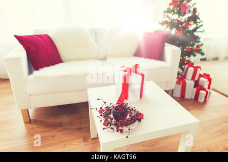 close up of christmas gift box on table at home Stock Photo