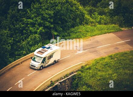 Camper Van on the Road. Motorhome Vacation Destination. Stock Photo