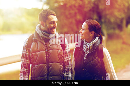 happy family walking with backpacks in woods Stock Photo