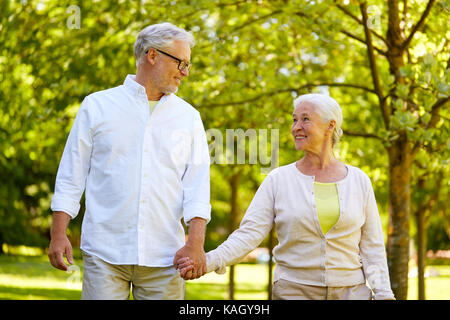 happy senior couple walking at summer park Stock Photo