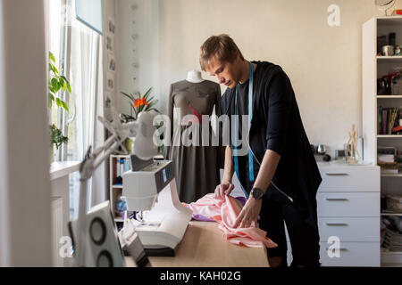fashion designer with cloth making dress at studio Stock Photo