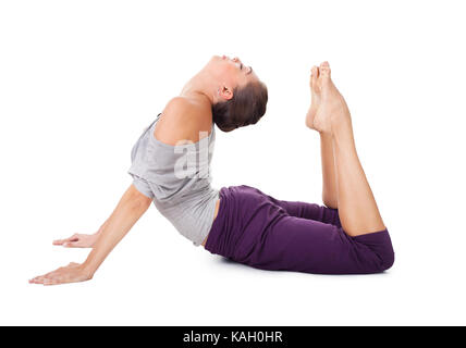 Active young woman exercising Cobra pose on yoga mat near river and  mountain stock photo