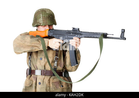 soldier shoots submachine gun isolated on white background Stock Photo