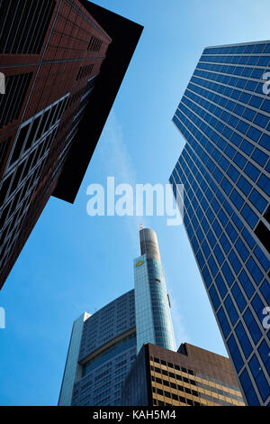 Frankfurt am Main, Germany - March 16, 2017: Tops of Japan Center, TaunusTurm and Commerzbank Tower against the bright blue sky with plane contrail, v Stock Photo