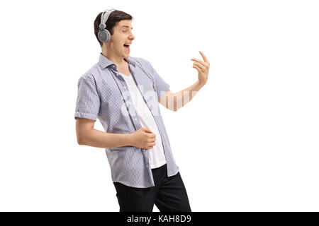 Young man wearing a pair of headphones and playing an air guitar isolated on white background Stock Photo