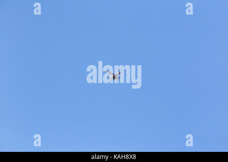 Drone camera flying against blue sky Stock Photo