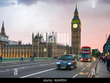 Taxi and red double-decker bus on the Westminster Bridge, Big Ben and Westminster Palace, motion blur, sunset, London, England