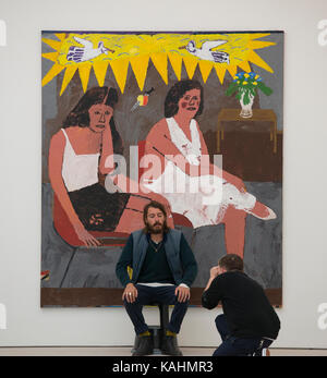Saatchi Gallery, London, UK. 26 September 2017. Saatchi Gallery’s autumn show ICONOCLASTS: Art out of the Mainstream opens on 27th Sept 2017, exactly 20 years after Charles Saatchi’s era defining exhibition Sensation which opened on 18th Sept 1997, launching the careers of Tracey Emin & Damien Hirst. ICONOCLASTS explores the work of 13 ground breaking British and international artists whose image-making practice is unorthodox. Photo: Artist Danny Fox sits in front of his work, Planned Parenthood Waiting Room, 2017. Credit: Malcolm Park/Alamy Live News. Stock Photo