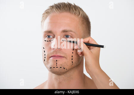 Close-up Of A Person's Hand Drawing Correction Line With Pen Stock Photo
