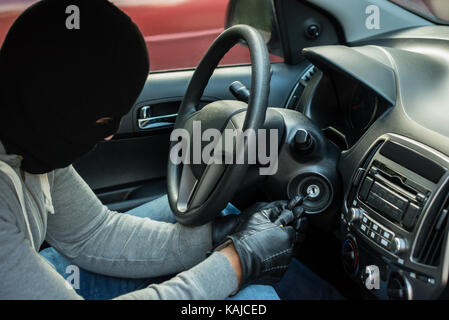 Thief With Mask Inserting Tool In Keyhole Stock Photo