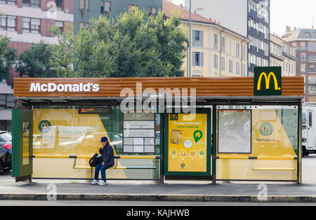 A bus stop in Milan, Lombardy, Italy sponsored by the fast-food giant, Mcdonald's Stock Photo
