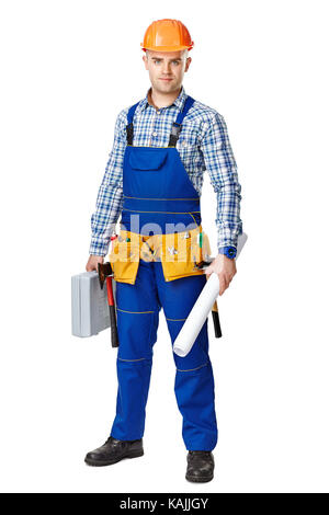 Full length portrait of young male construction worker with toolbox and drawings, wearing protective clothes, helmet and tool belt isolated on white b Stock Photo