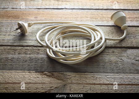 Extension Cord on Wooden Background Stock Photo