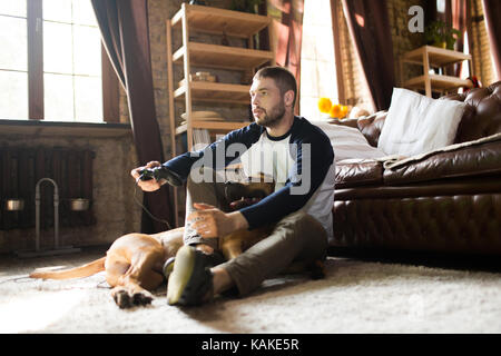 Man and dog on the floor at home. Stock Photo