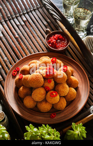 potato croquette with spicy hot peppers sauce. bar appetizer Stock Photo