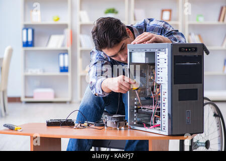 Computer repairman on wheelchair working Stock Photo