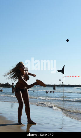 Playing Matkot ( paddle ball ) on the beach in Tel-Aviv. Stock Photo