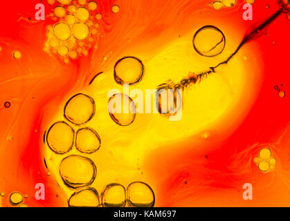 bubbles in water formed by injection yellow red orange background Stock Photo