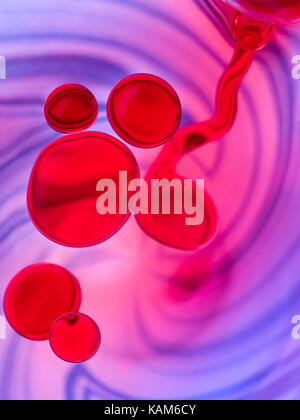 red oil bubbles on a blue spiral background Stock Photo