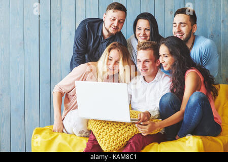 Group of creative young Friends Hanging Social Media Concept. People Together Discussing Creative Project During Work Process, play games or watch video film Stock Photo