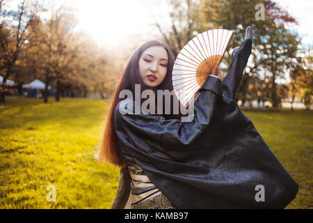 Dancing young woman in kimono, the Asian costume Stock Photo