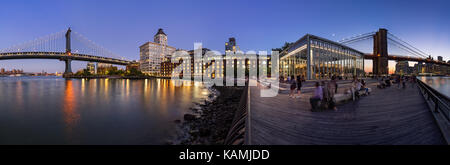 Panoramic night view of the newly renovated Brooklyn waterfront between the Manhattan Bridge and Brooklyn Bridge. Dumbo, Brooklyn, New York City Stock Photo