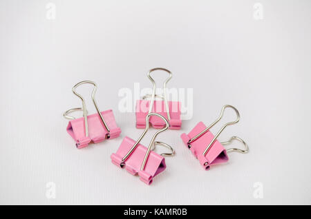 A Studio Photograph of a Group of Pink Bulldog Clips Stock Photo