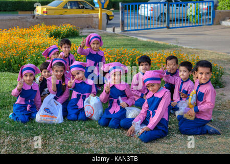 Fars Province, Shiraz, Iran - 19 april, 2017: A group of children, boys and girls of pre-school age, dressed in pink and blue uniforms, posing for pho Stock Photo