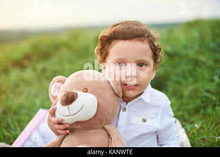 Portrait of hispanic boy kid holding teddy bear Stock Photo
