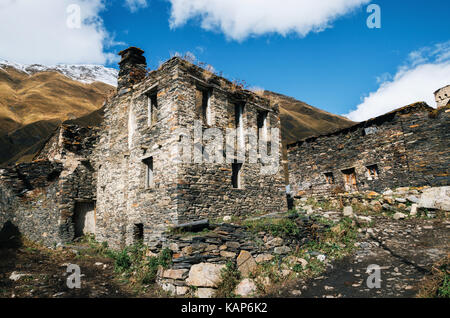 Ruined and abandoned traditional Svan towers and machub house with flagstone in Ushguli commune, Upper Svaneti, Georgia. Georgian landmark Stock Photo